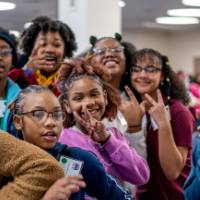 Girls of Color Summit previous event with a group posing for a picture at the event